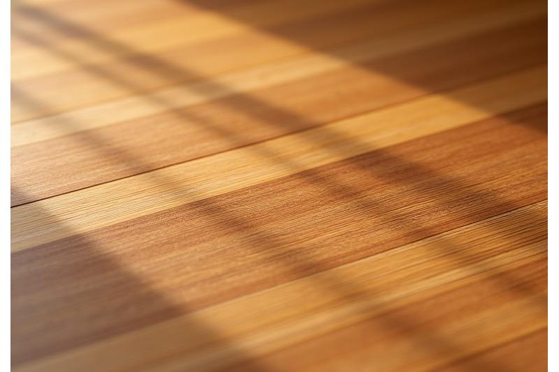 A close-up of a beautifully crafted bamboo acoustic ceiling panel and flooring, showcasing texture and natural warmth.