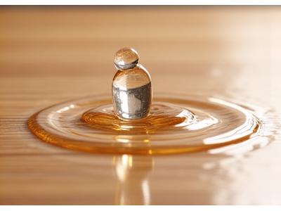 Water droplet beading on bamboo flooring surface, demonstrating water resistance